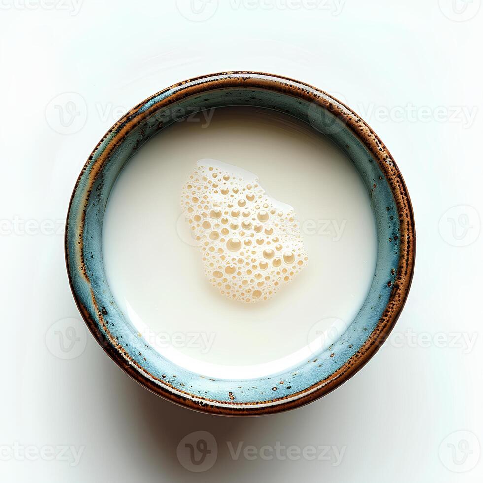 Milk in cup isolated on white background with shadow. Milk in blue cup full of calcium top view photo
