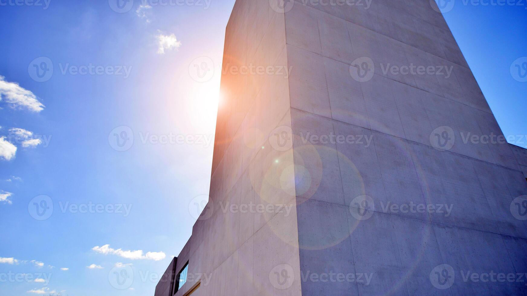 Sunlight and shadow on surface of white Concrete Building wall against blue sky background, Geometric Exterior Architecture in Minimal Street photography style photo
