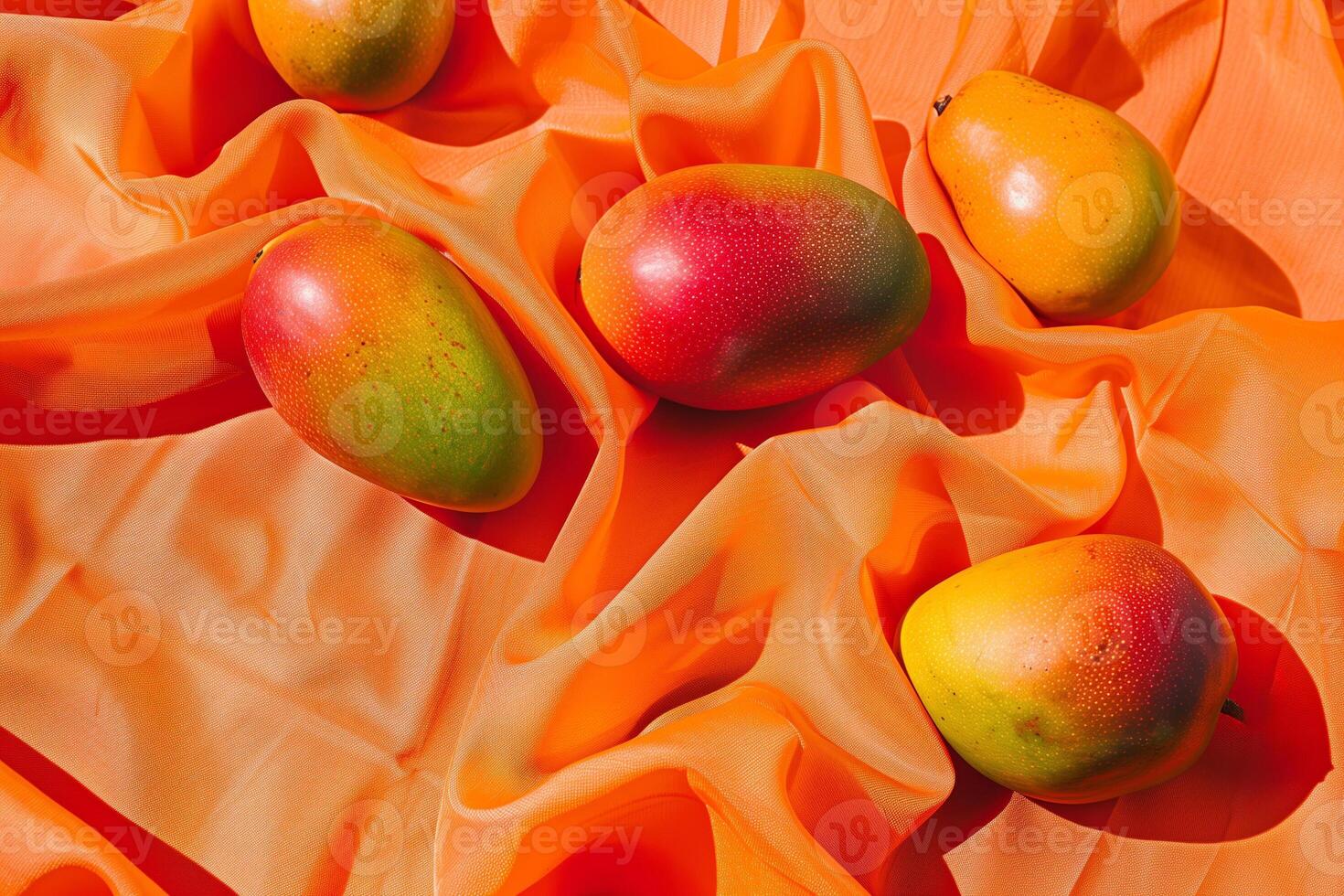 ripe mangoes on linen isolated on an orange gradient background photo