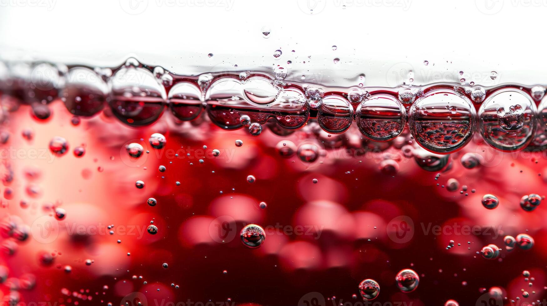 Close up of red wine bubbles in a glass, macro shot, isolated on white background photo