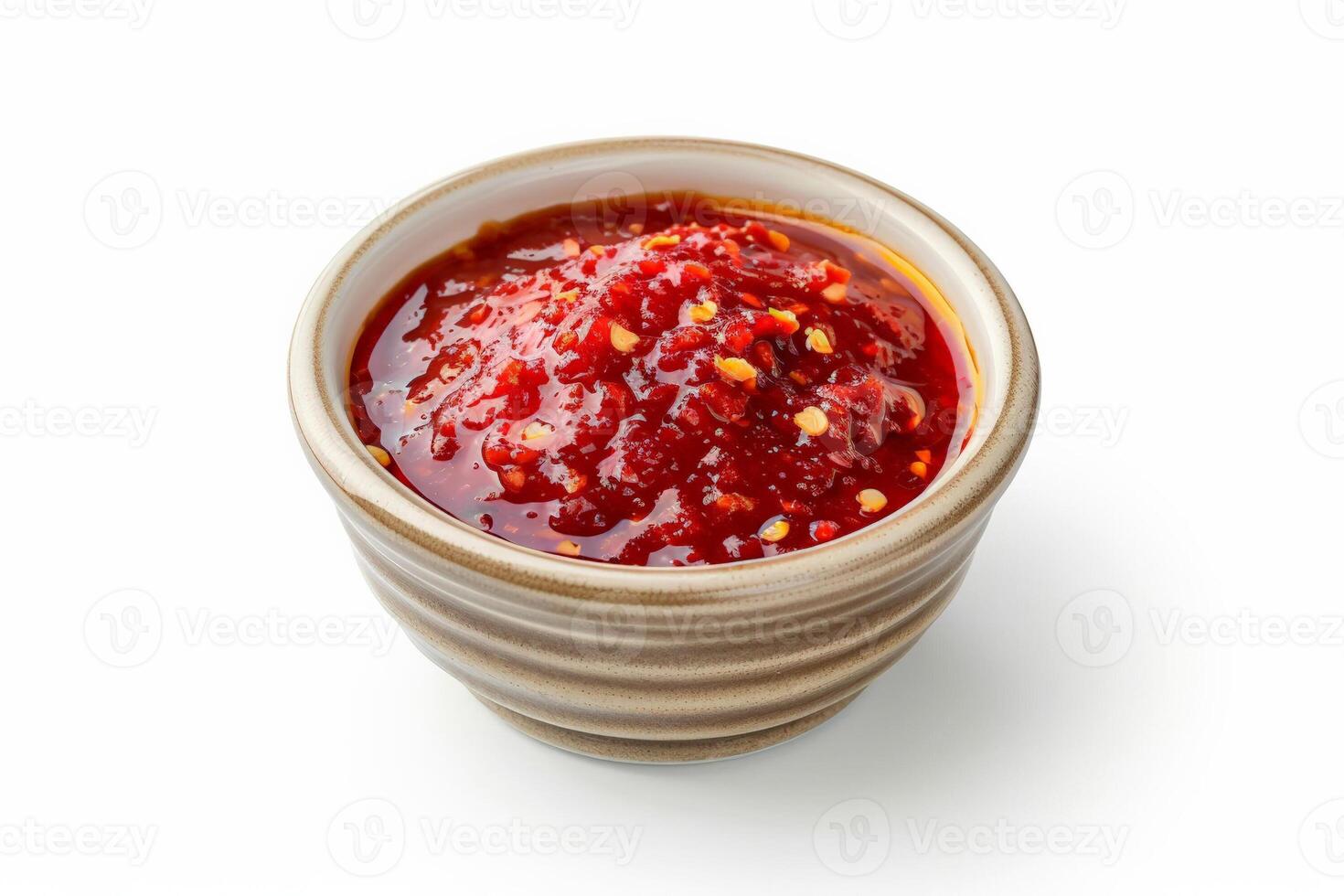 Small ceramic dish of spicy chili sauce, bright red with visible chili flakes, isolated on white photo