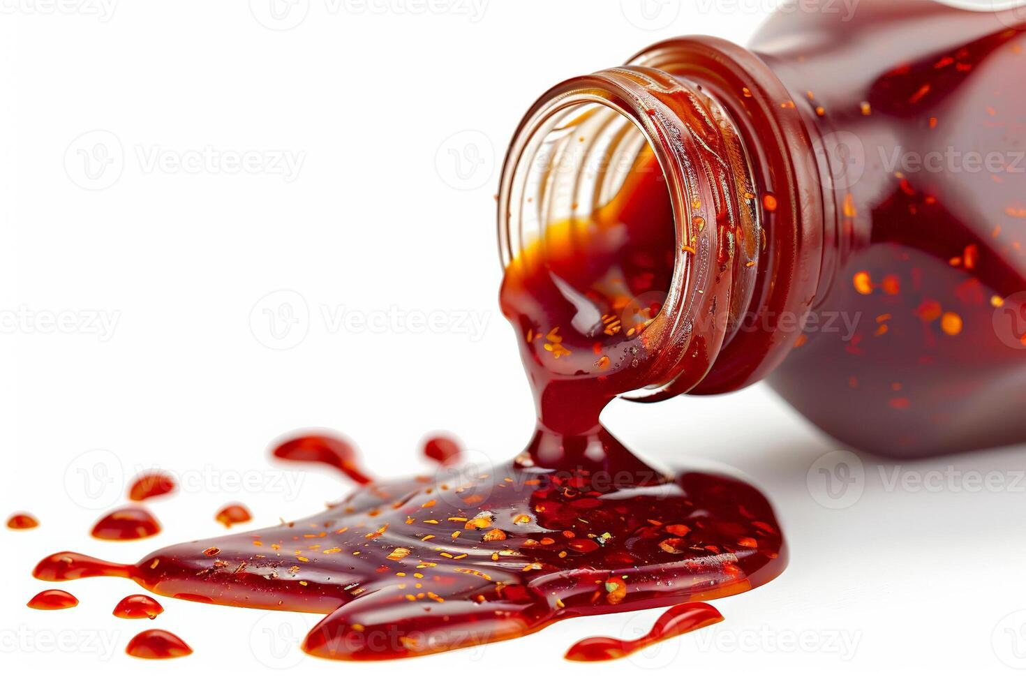 Bottle of hot sauce tipped over, spicy red sauce flowing out, isolated on a white background photo