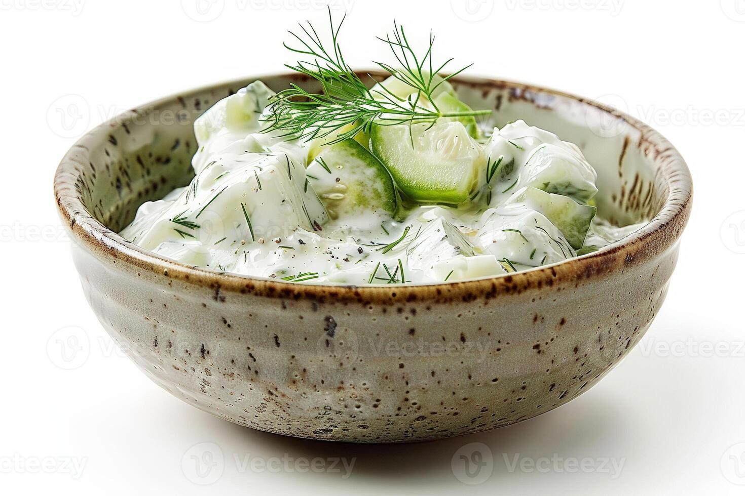 Ceramic dish of tzatziki, cucumber and dill visible, refreshing and cool, isolated on white photo