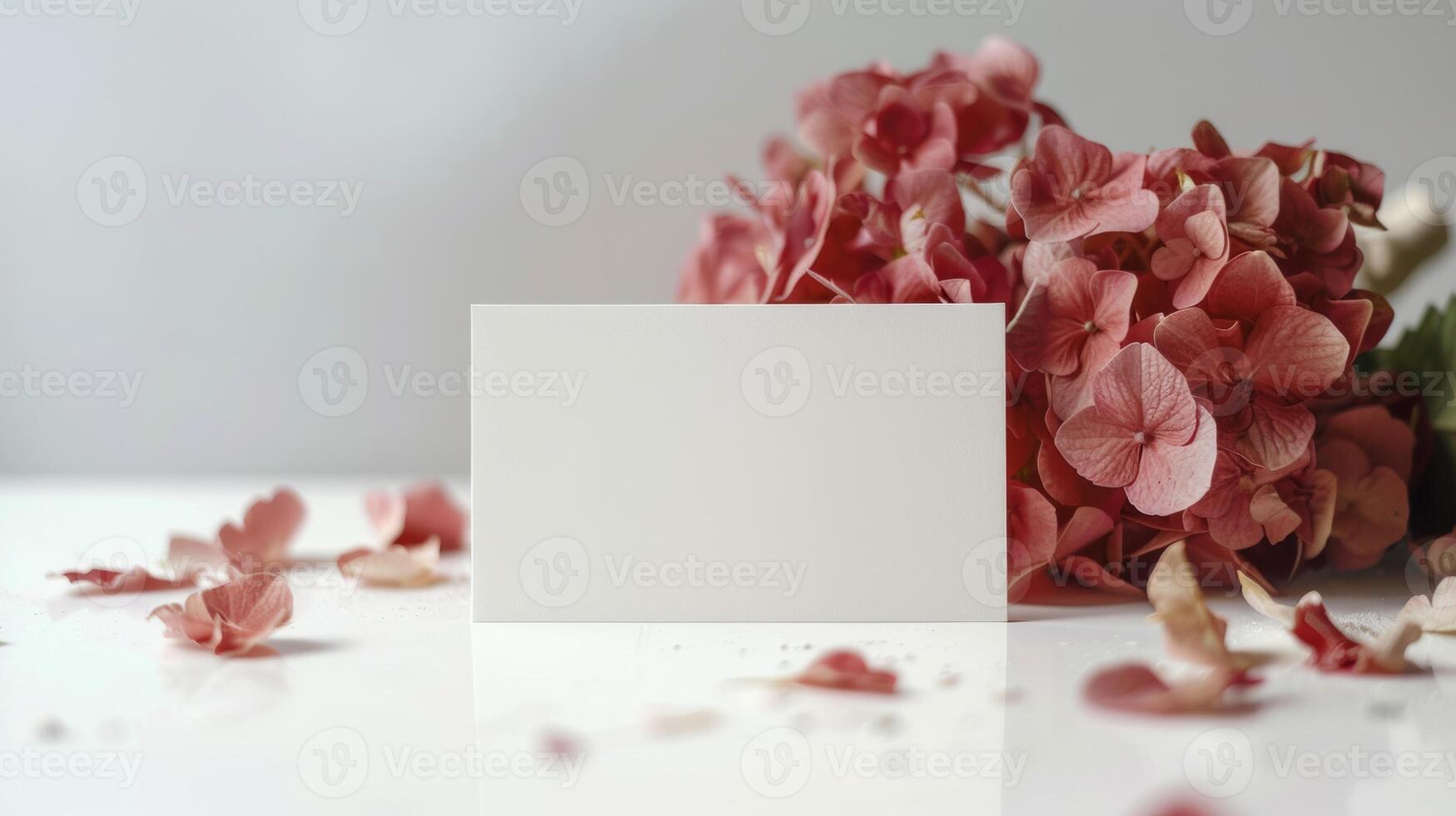 mockup of a white card beside red hydrangea bouquet, soft pastel tones photo