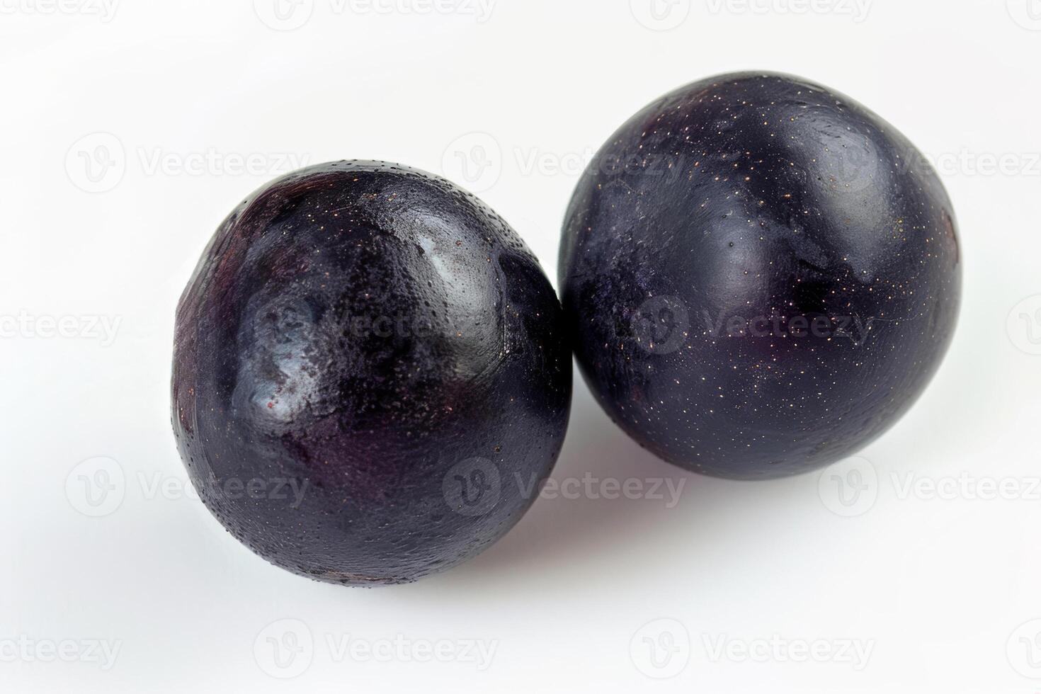 two acai berries, top view, vivid and distinct on a white background photo