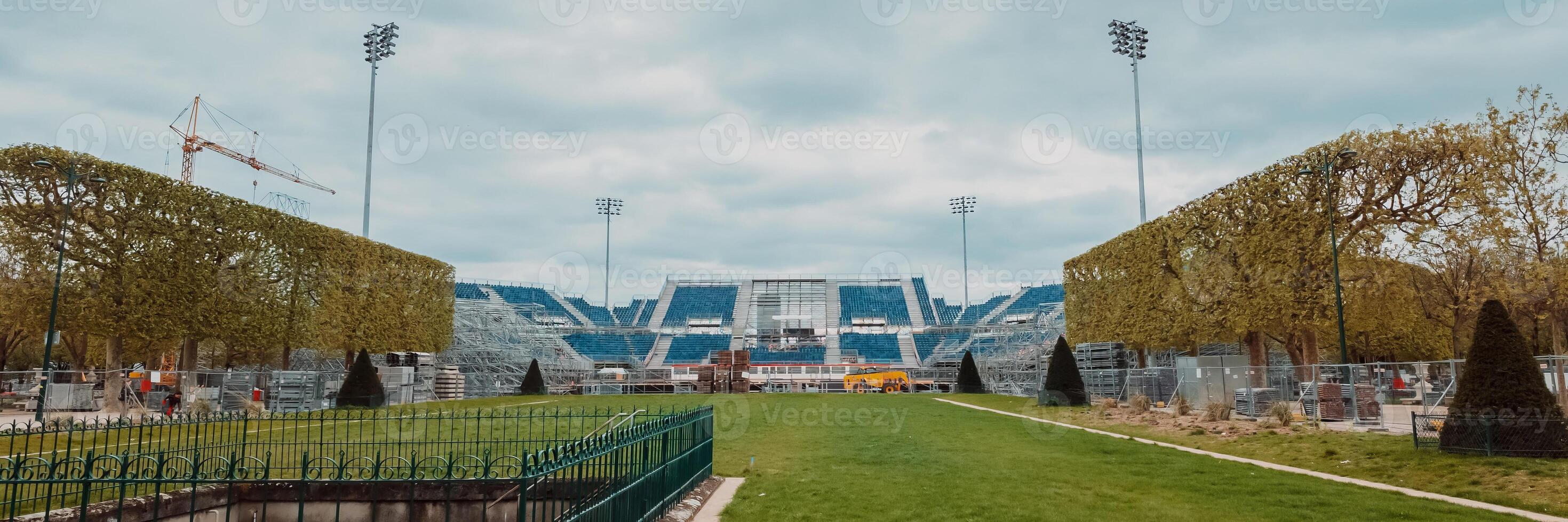 Empty sports stadium undergoing renovation with construction crane, signifying concepts of sports, development, and related to events like off season maintenance photo