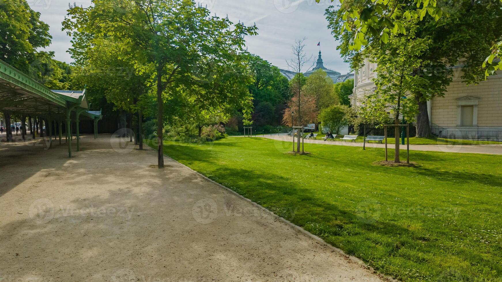 Tranquil urban park with lush greenery and a walking path, ideal for Spring and Earth Day backgrounds, promoting outdoor activities and mental health awareness photo