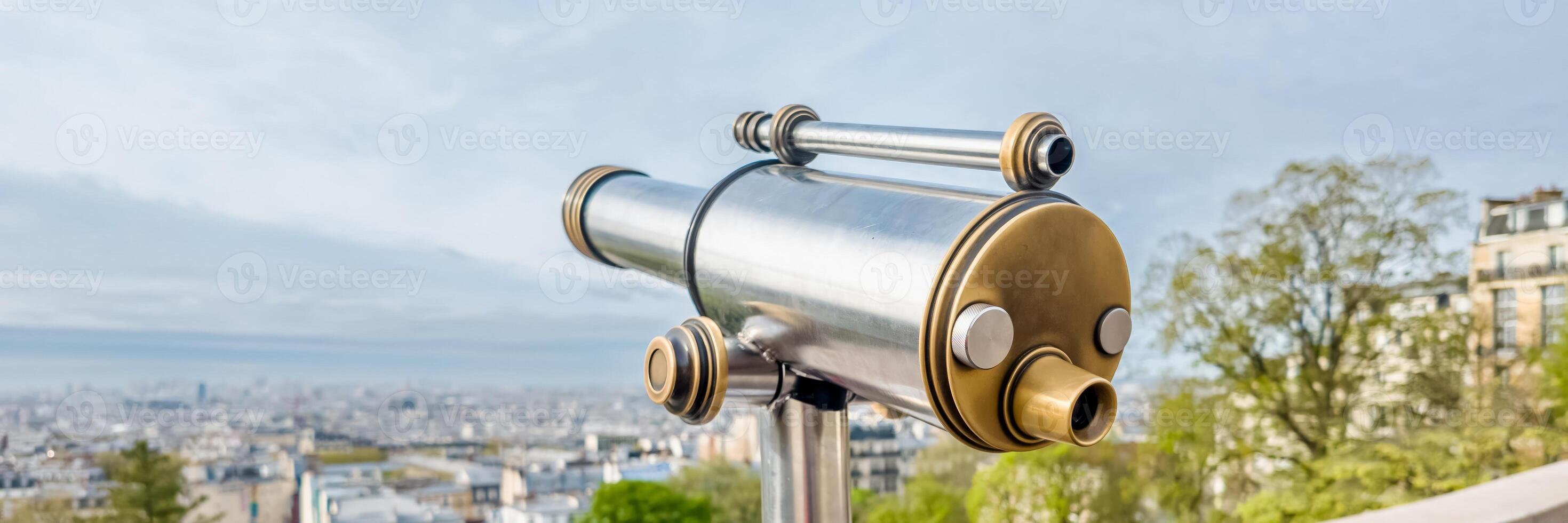Vintage looking public telescope with expansive city view from high vantage point, ideal for urban exploration and travel themes Related concepts, tourism, sightseeing photo