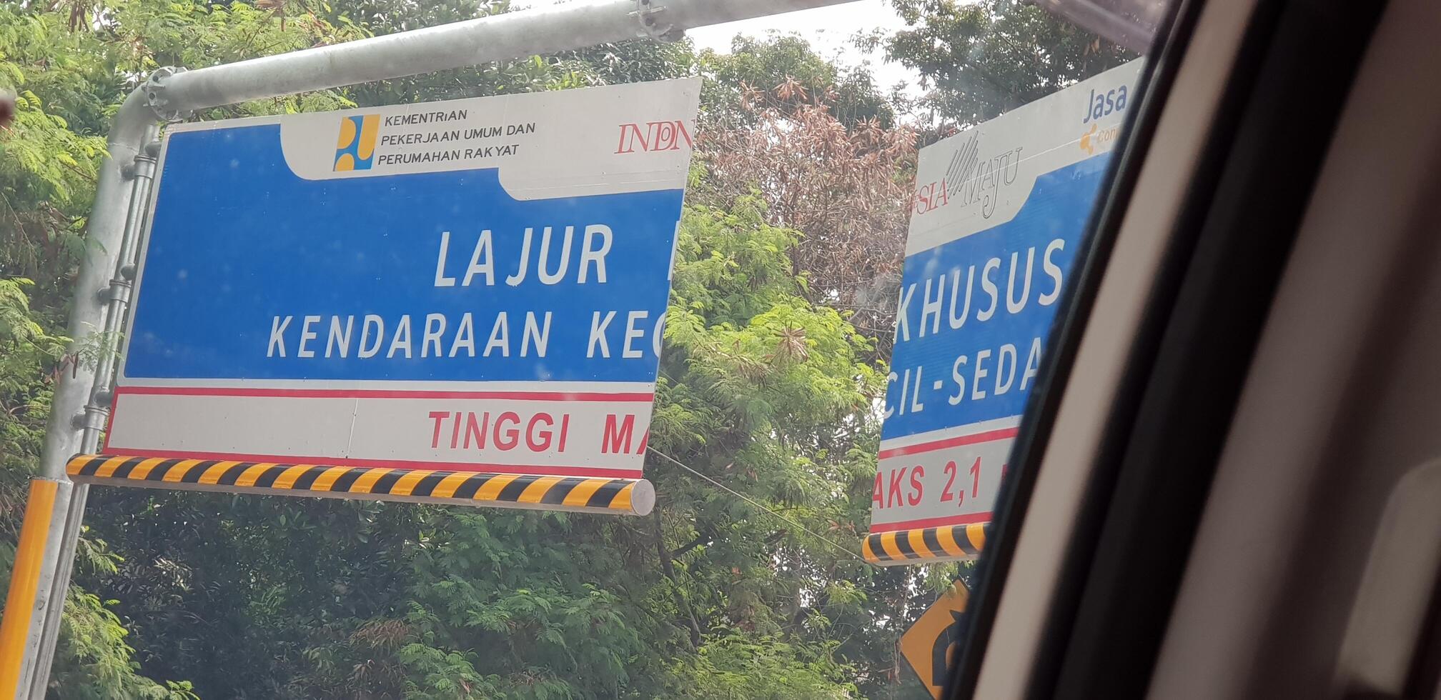 Bekasi, Indonesia in July 2020. A passenger car photographing the vehicle size limitation portal on the Japek Elevated Toll Road photo