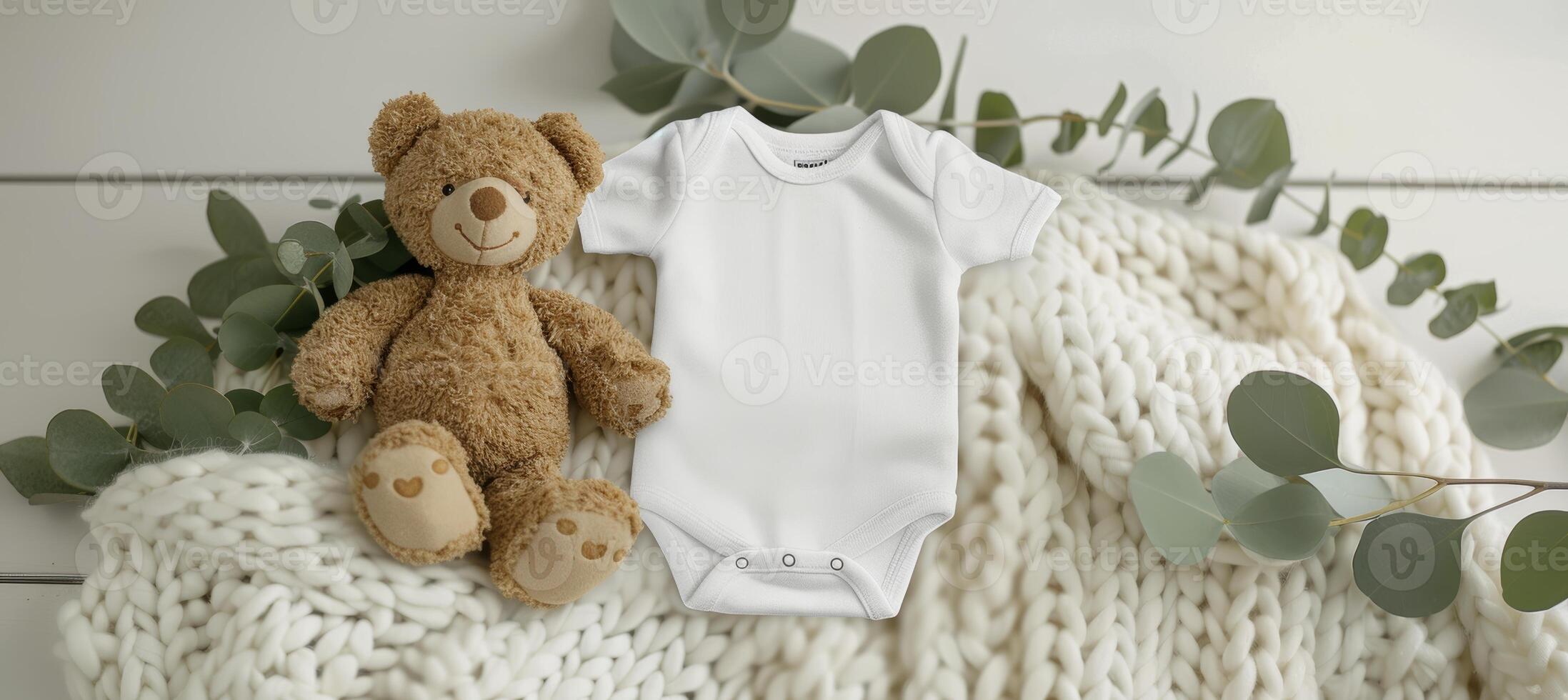 Infant onesie mockup with teddy bear toy and eucalyptus branch on white blanket throw background photo