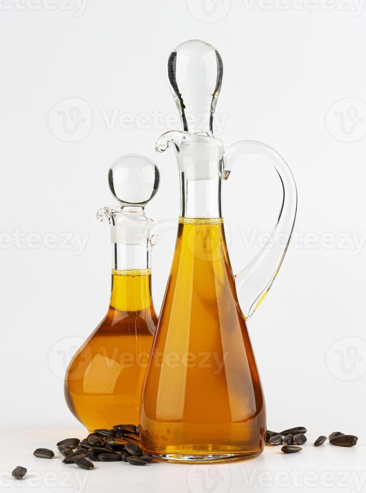 Decanter with sunflower oil isolated on white background photo