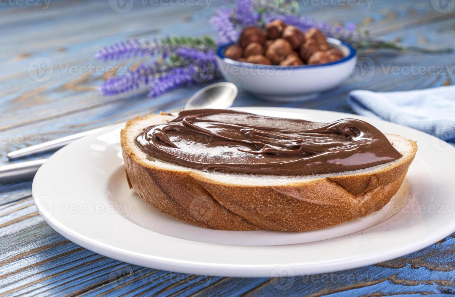 Spreading hazelnut cream on bread, chocolate nut butter photo