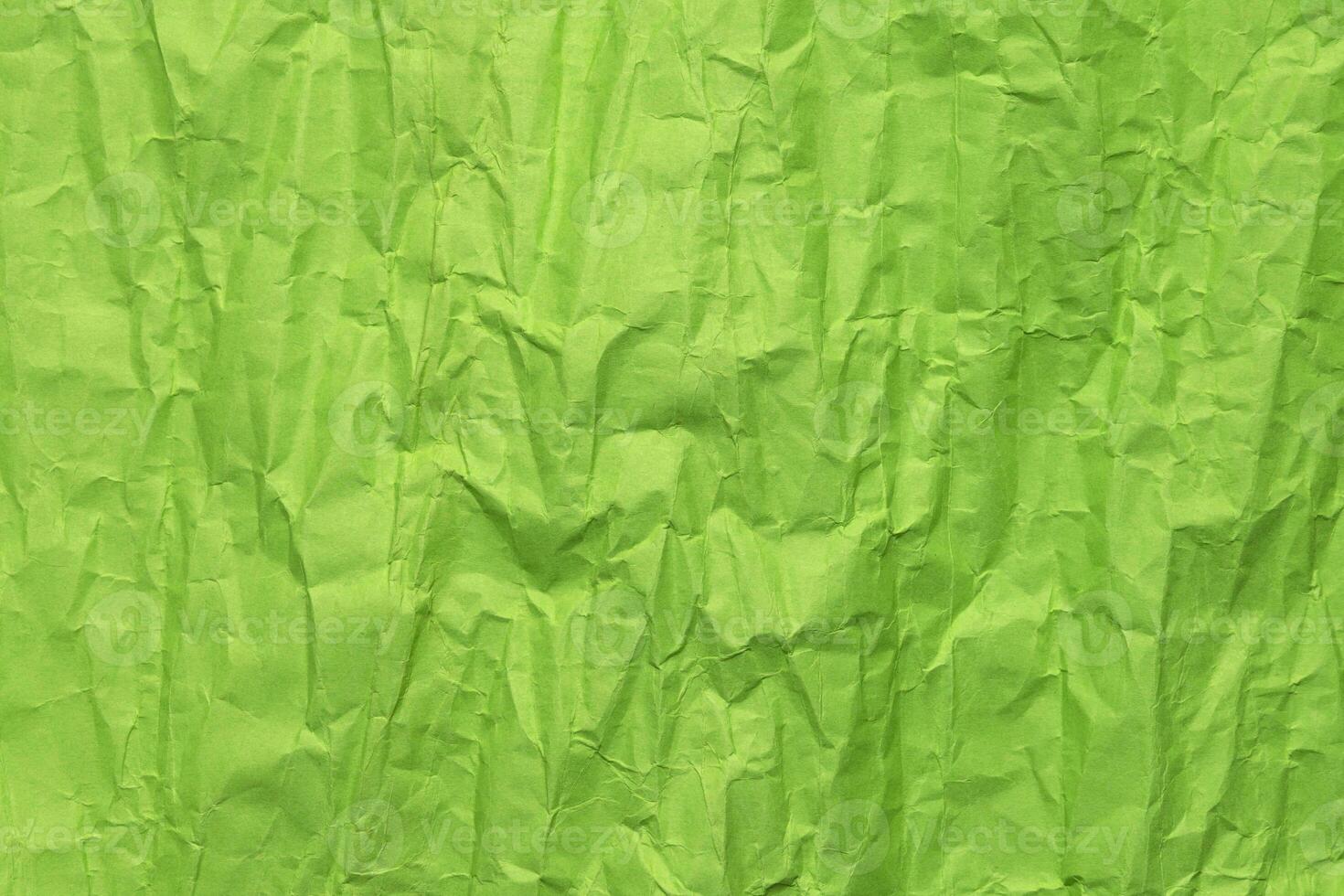 Green crumpled paper texture, grunge background photo