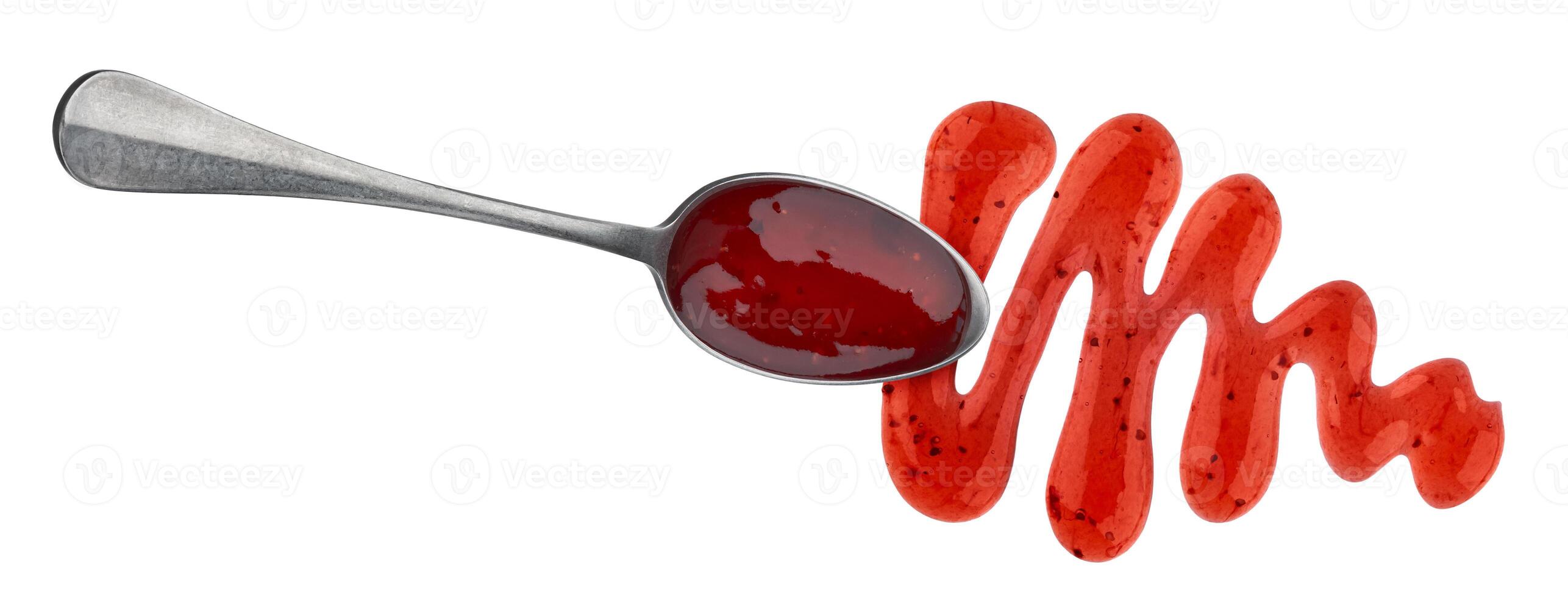 Red berry jam in spoon isolated on white background photo