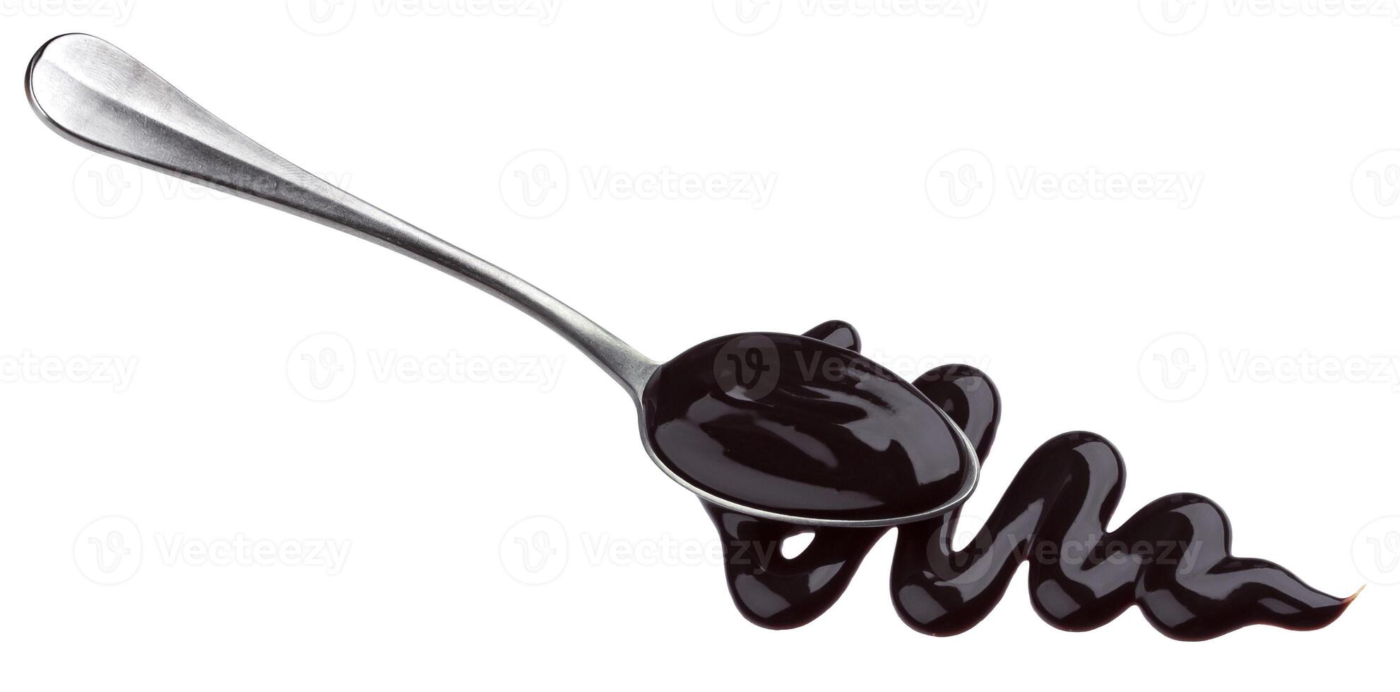 Sweet chocolate sauce in spoon isolated on white background photo