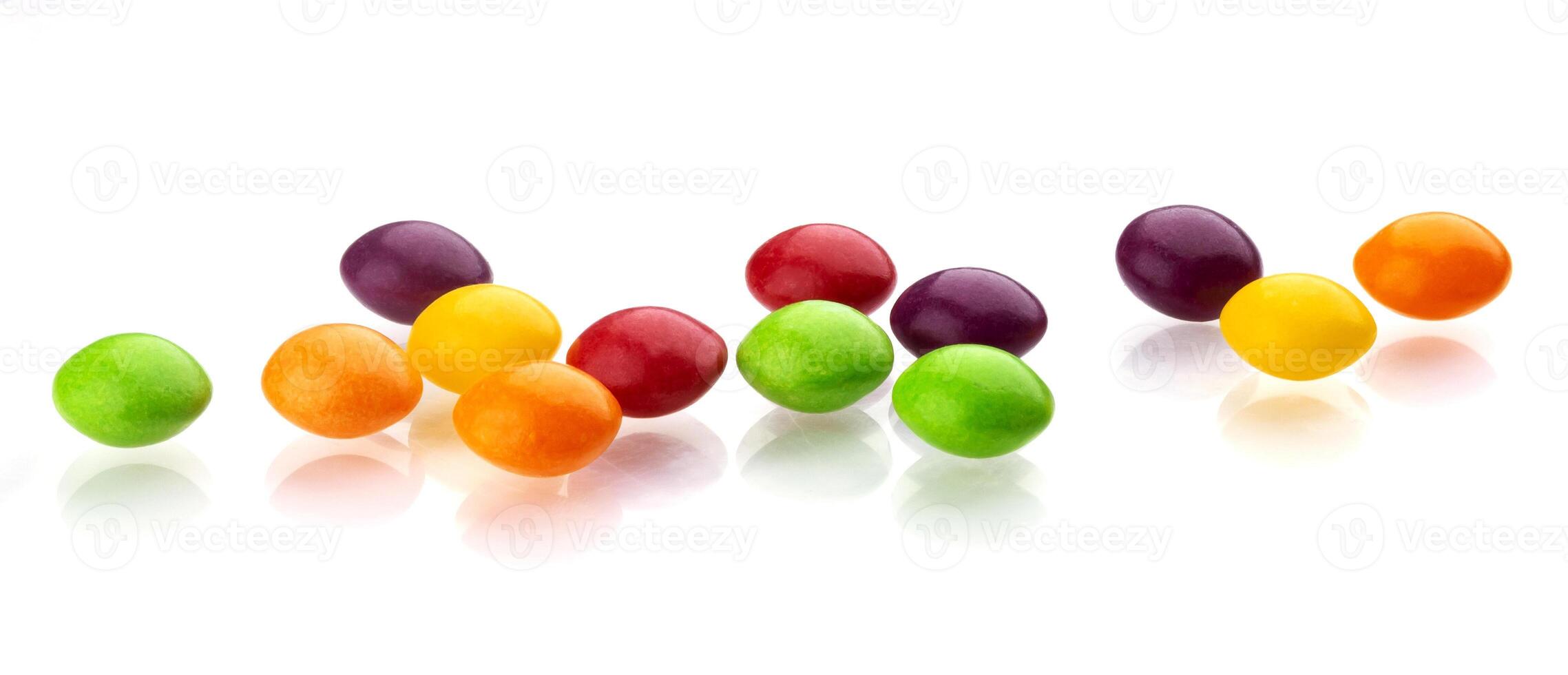 Multicolor shiny nuts and raisins dragee isolated on white background photo