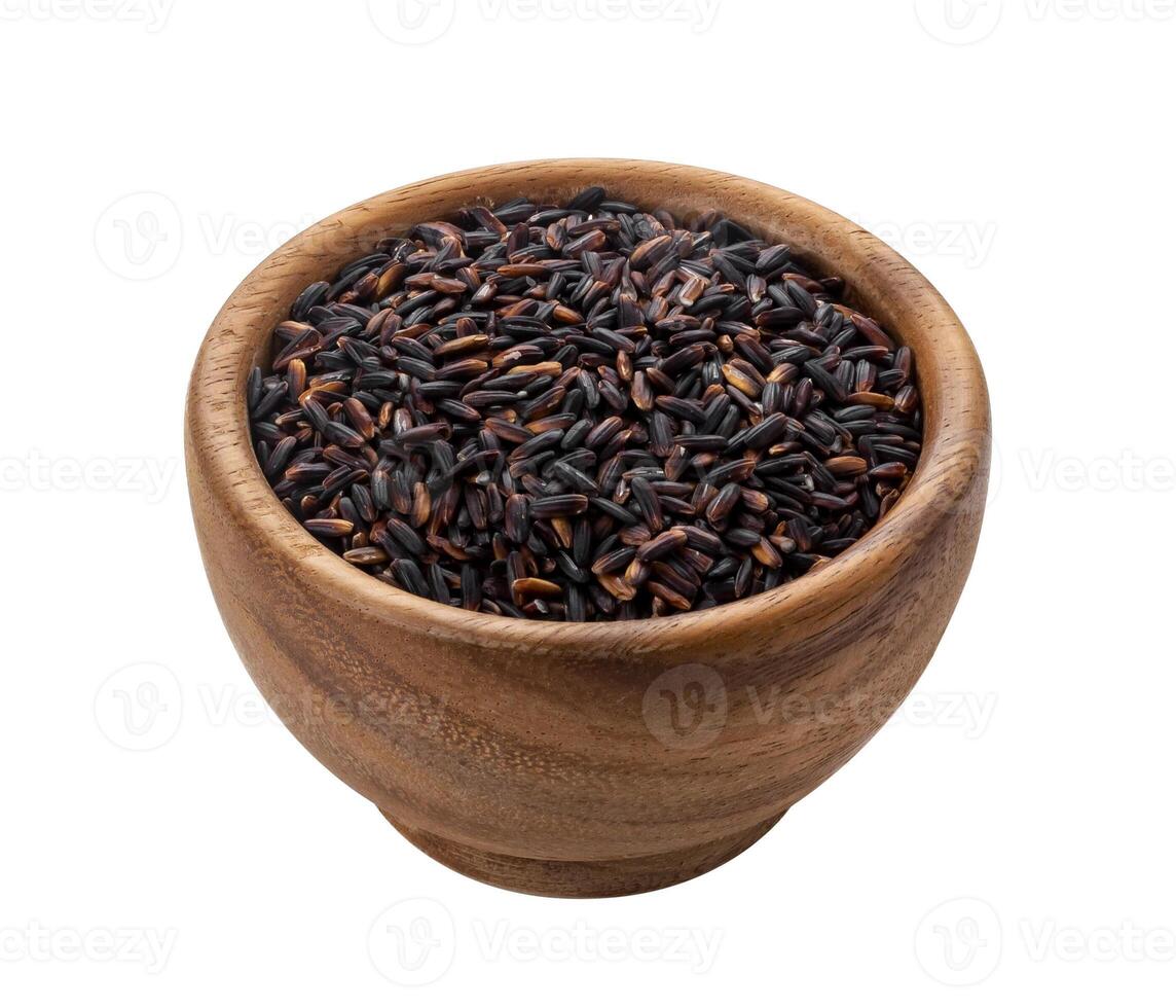 Black rice groats in wooden bowl isolated on white background photo