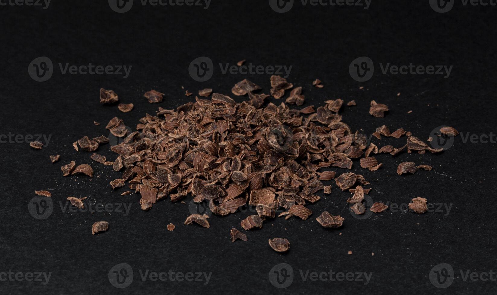 Pile of ground chocolate on black background photo