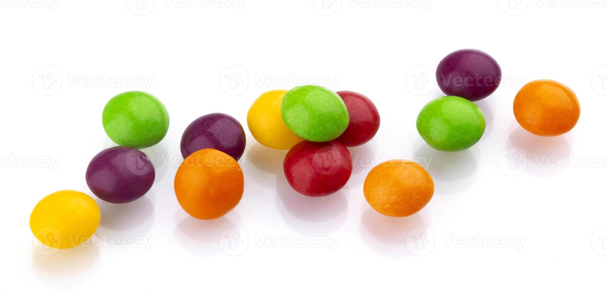 Multicolor shiny nuts and raisins dragee isolated on white background photo