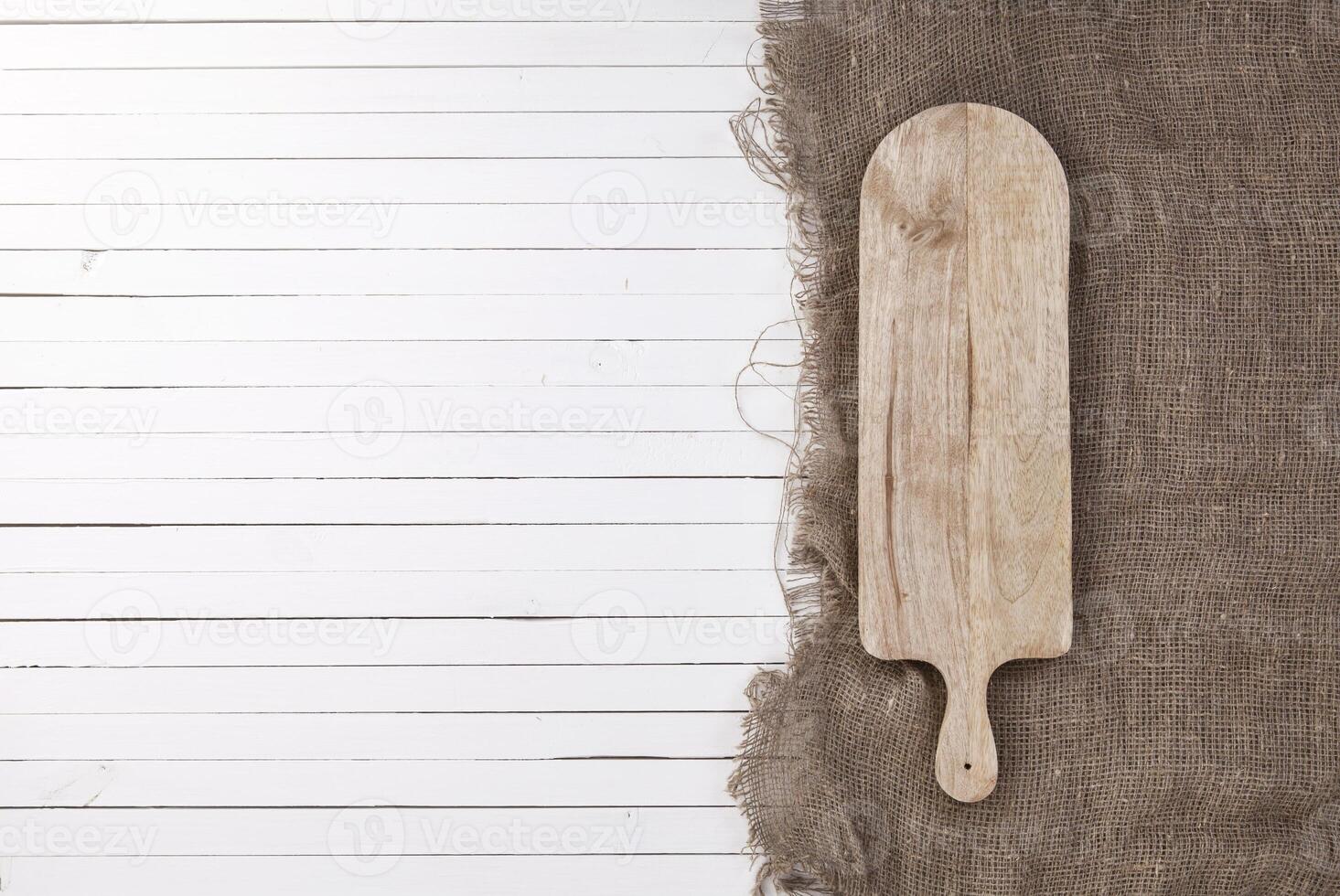 Empty cheeseboard on white wooden background, top view photo