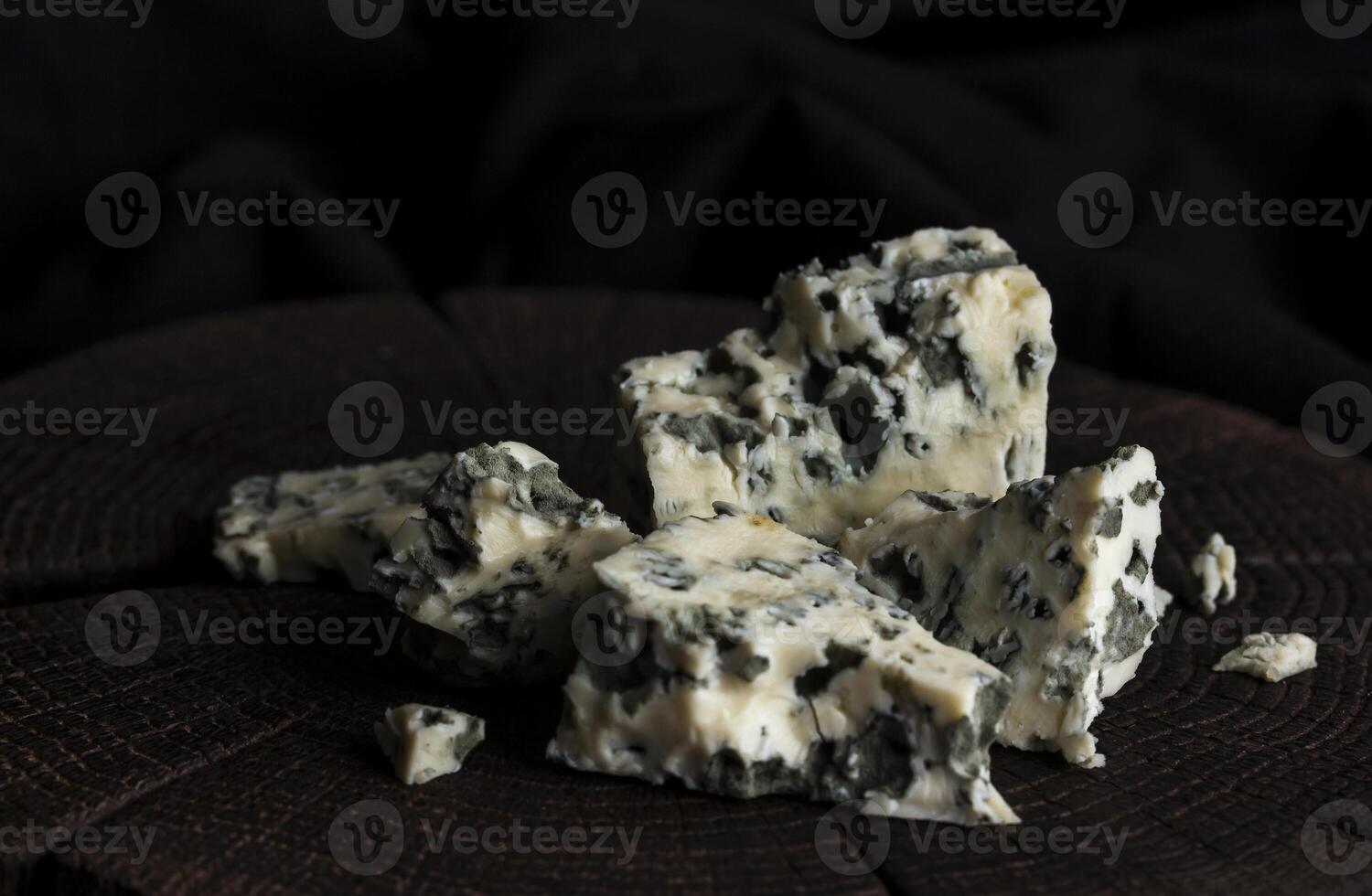 Danish blue cheese on black wooden background, with copy space photo