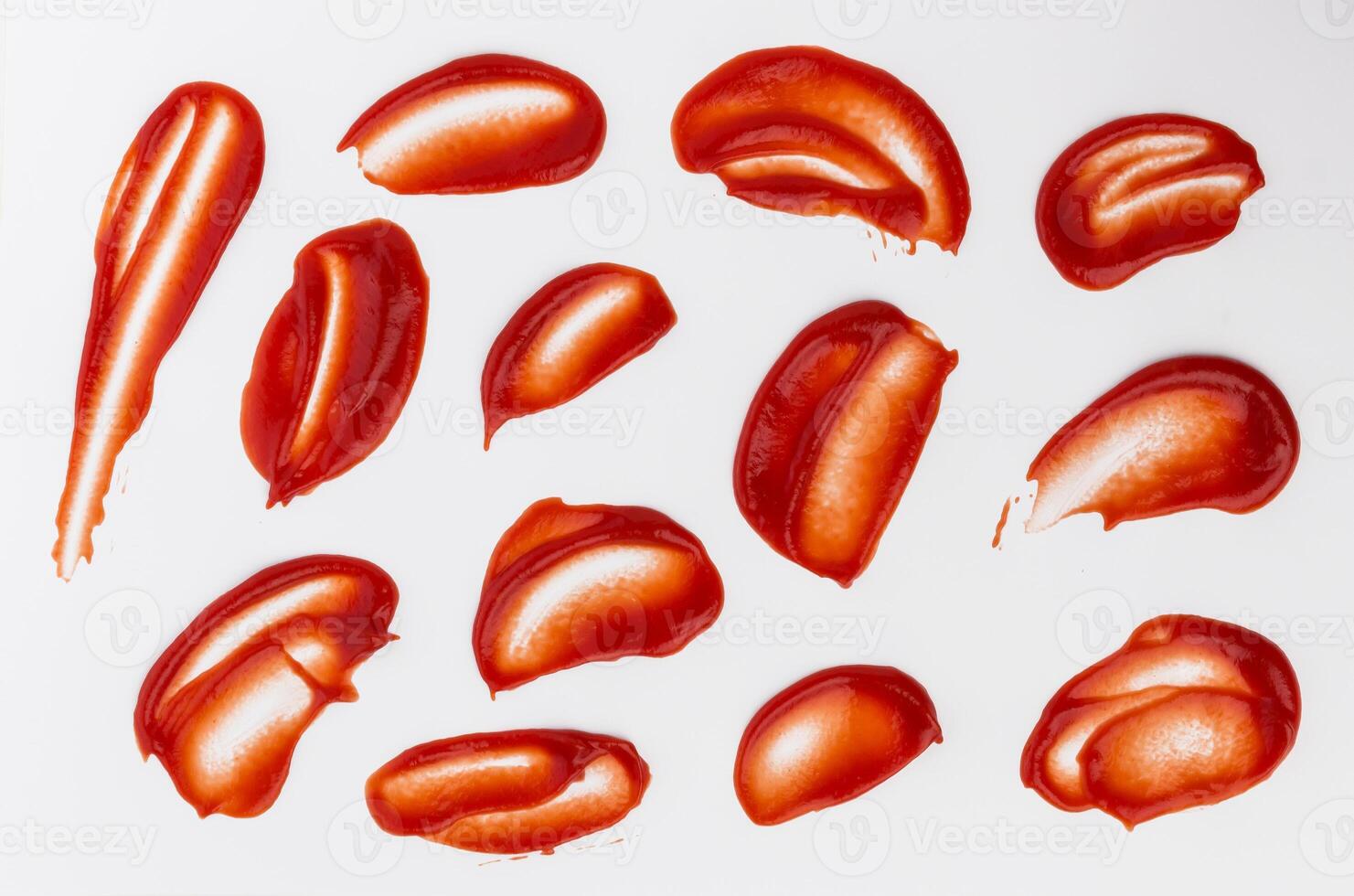 Ketchup stains and splashes isolated on white background photo