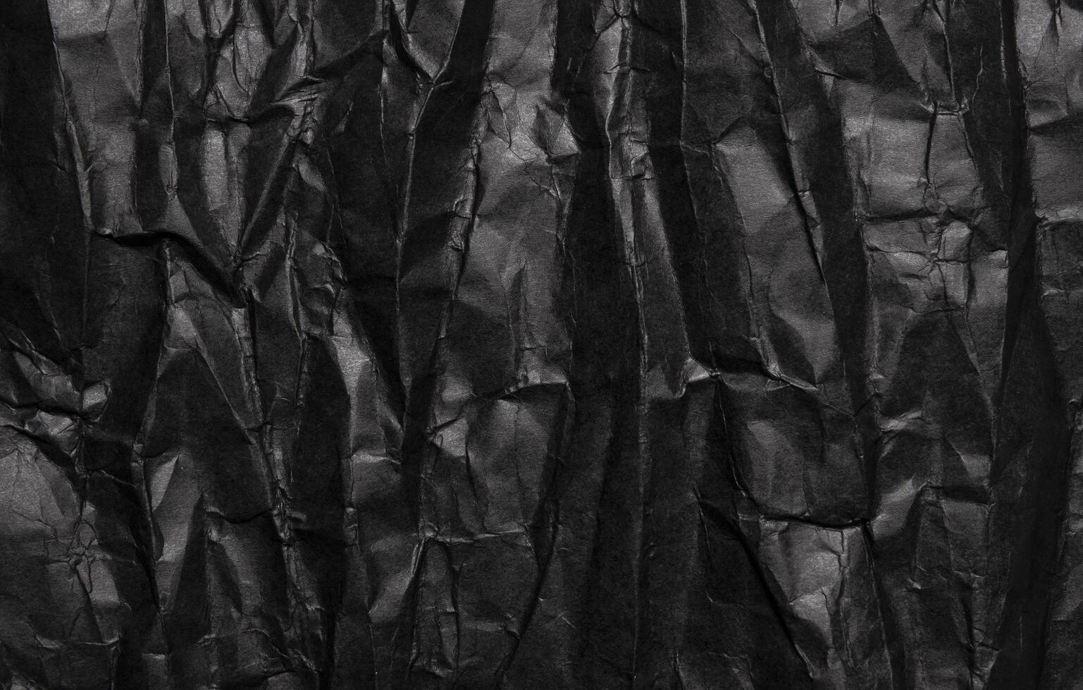 Black crumpled paper texture, grunge background photo