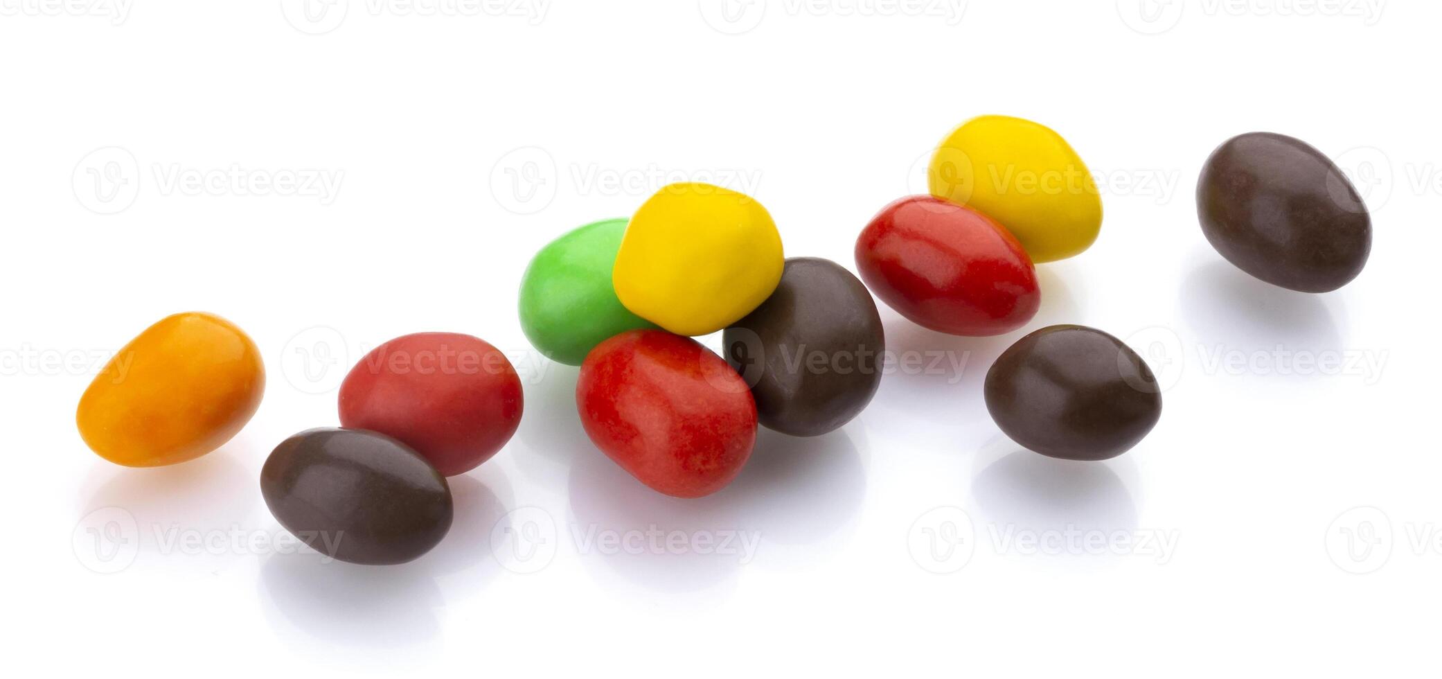 Multicolor shiny nuts and raisins dragee isolated on white background photo