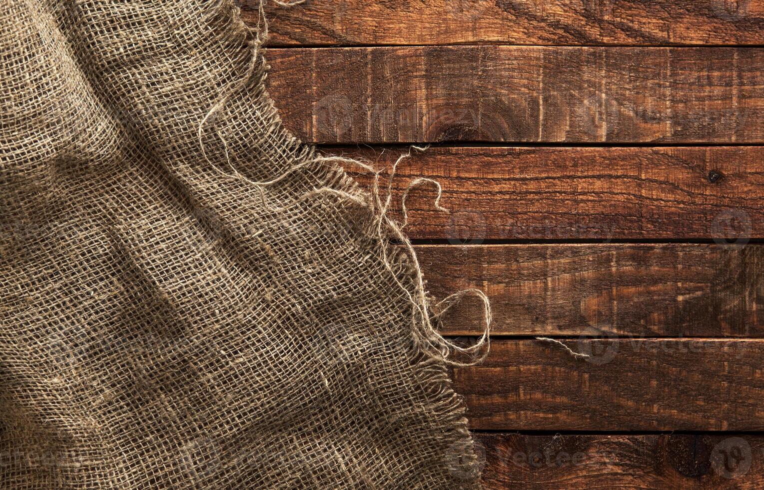 Burlap hessian or sacking on wooden background photo
