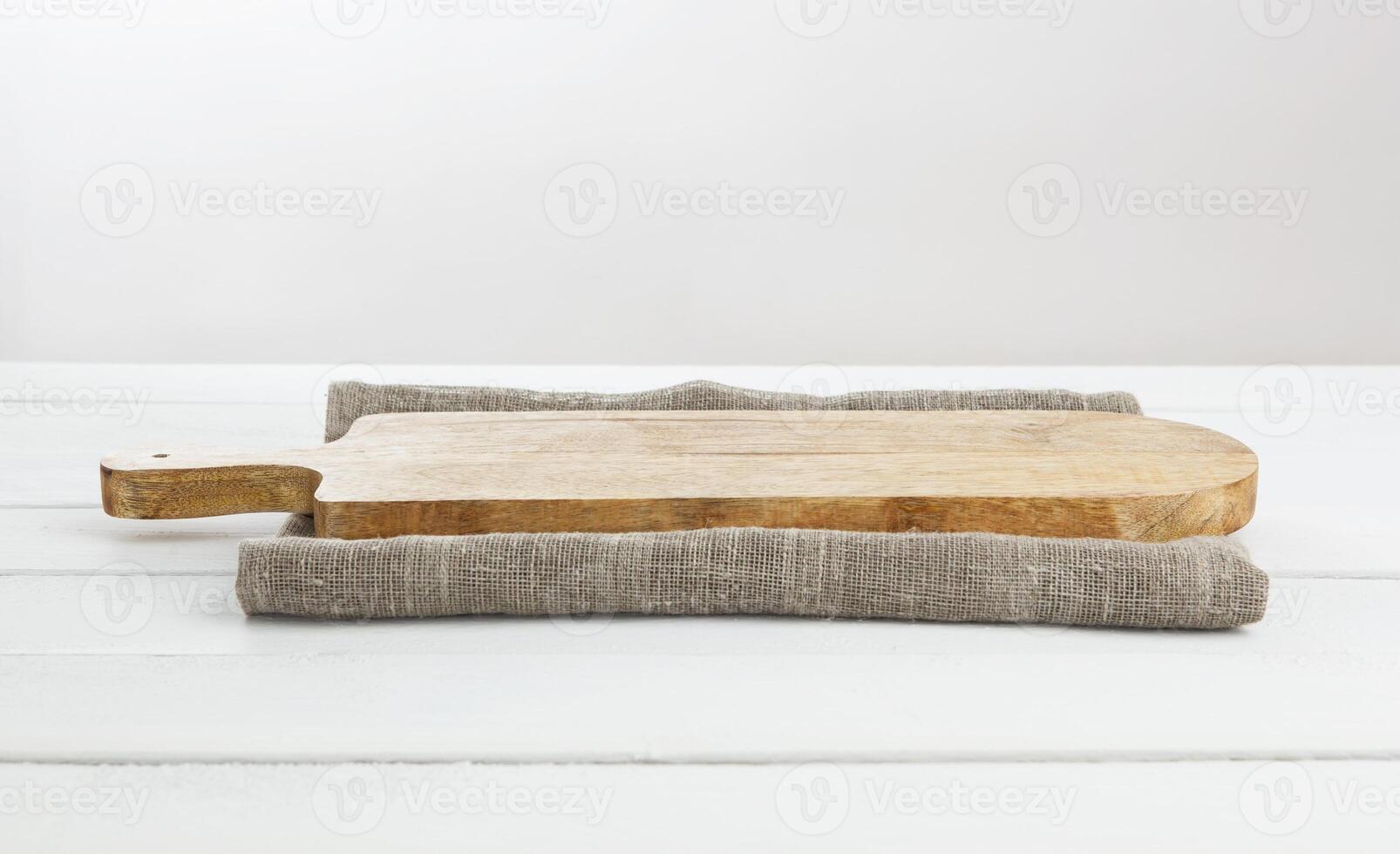 Empty cutting board on white wooden table. photo