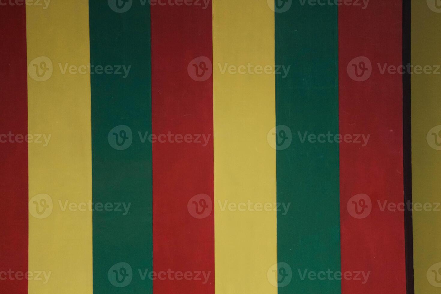 A vertical striped wall in yellow green red which is one of the mainstays of the Aceh Special Pavilion in Taman Mini Indonesia Indah. photo