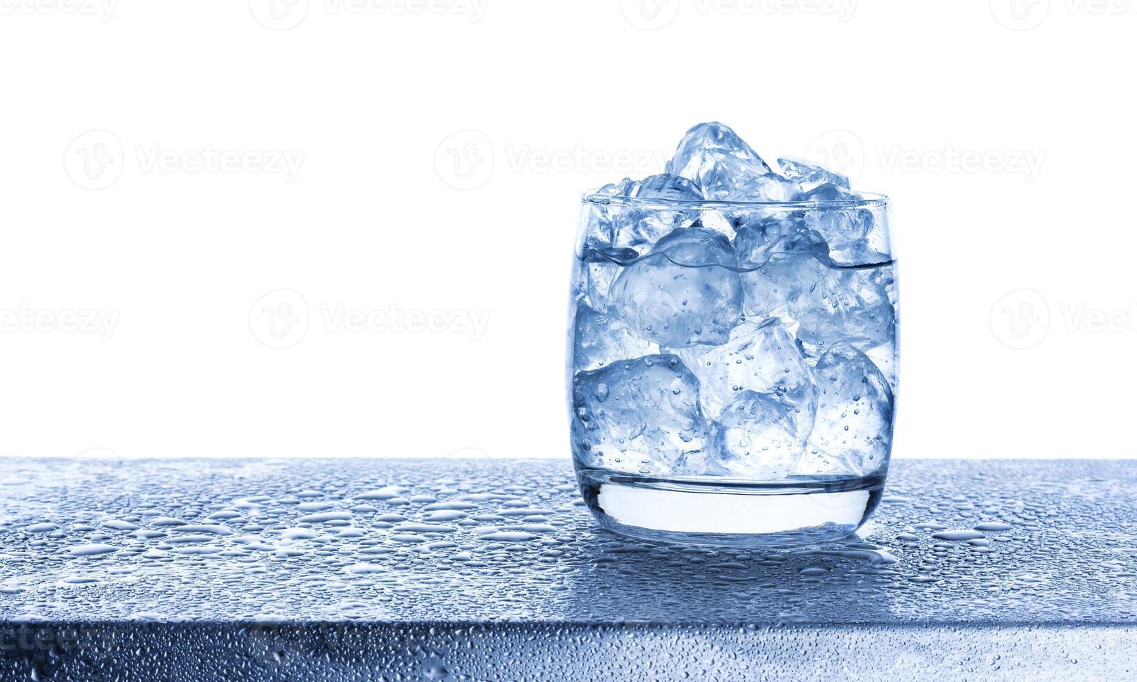 Water with crushed ice cubes in glass on white background photo