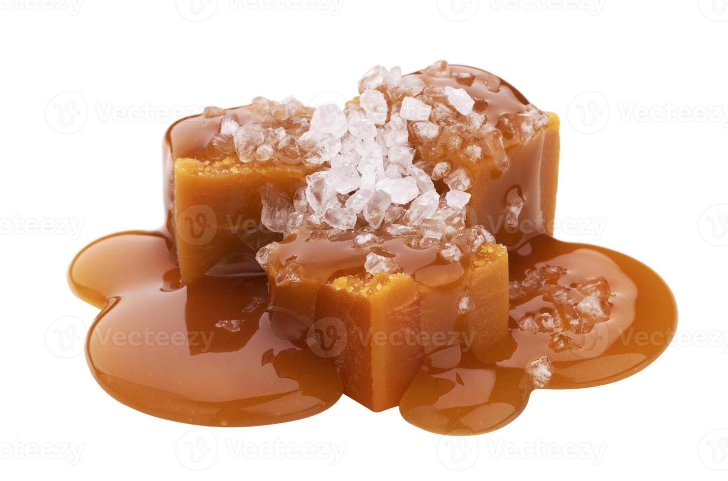 Toffee candies with caramel sauce and salt isolated on white background photo