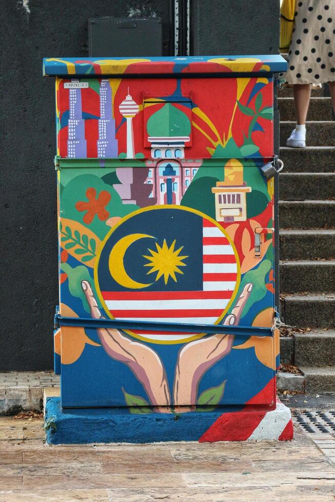 Kuala Lumpur, Malaysia on May 22, 2023. An electrical panel decorated with paintings of the Malaysian flag and landmarks. photo