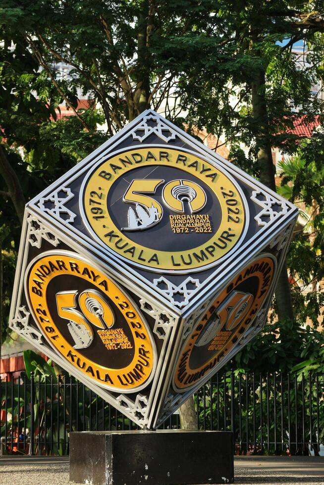 Kuala Lumpur, Malaysia on May 21 2023. A cube-shaped monument to commemorate Dirgahayu Bandar Raya Kuala Lumpur 1972 - 2022. Located in city center photo