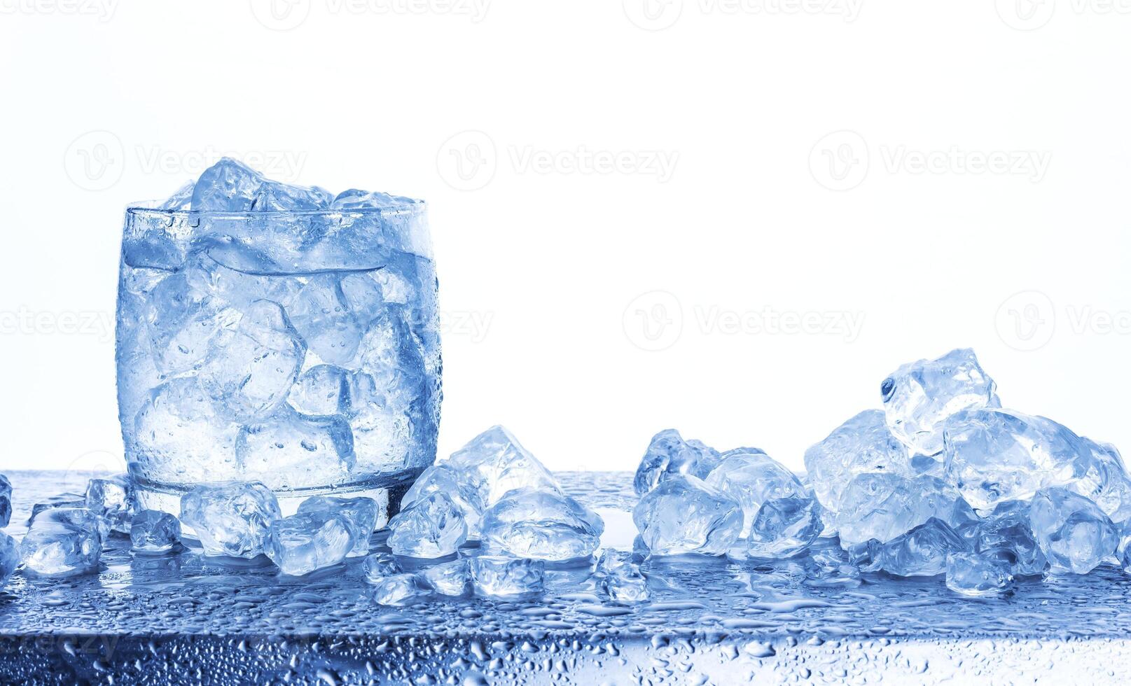 Water with crushed ice cubes in glass isolated on white background photo