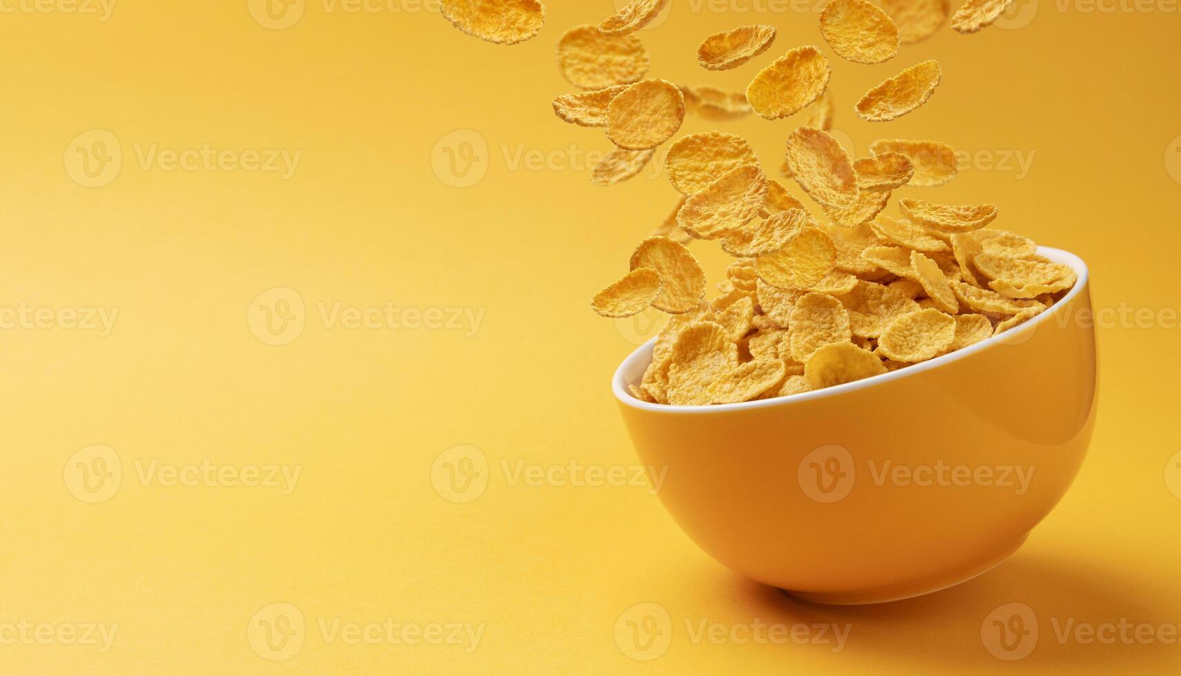 Ceramic bowl with falling corn flakes on yellow background photo