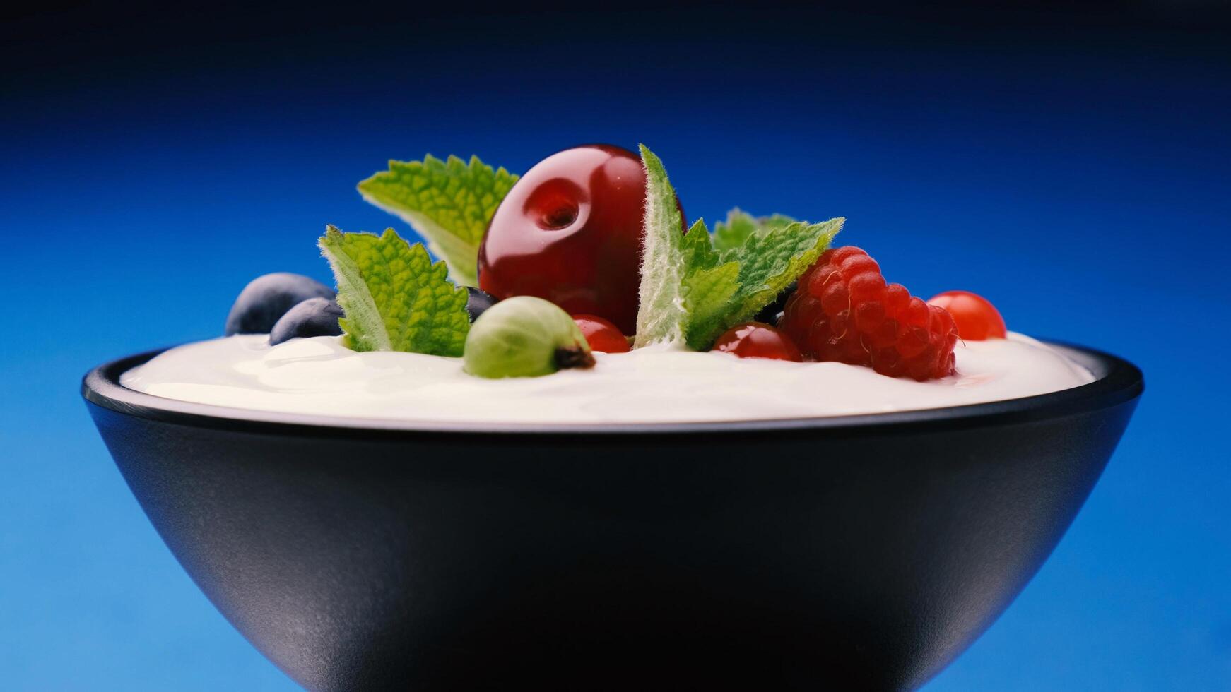 Bowl of yogurt with wild berries strawberry, blueberry, raspberry photo
