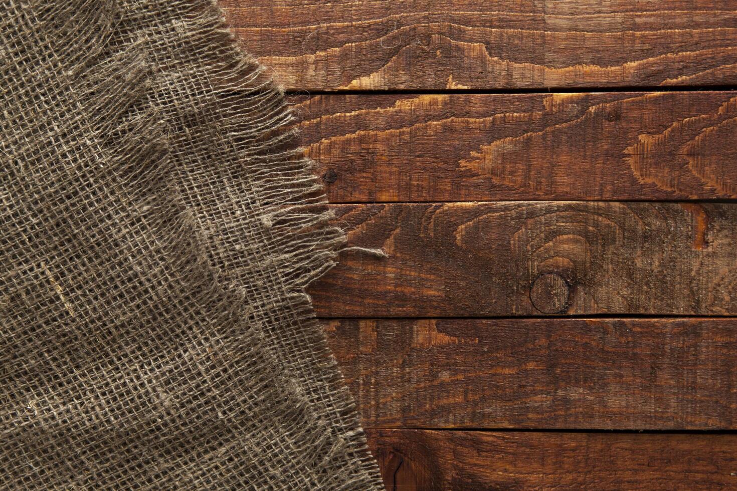 Wood table with old burlap cloth photo