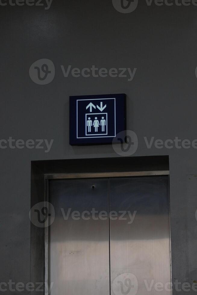 Elevator or lift sign board, with blue and white lines photo