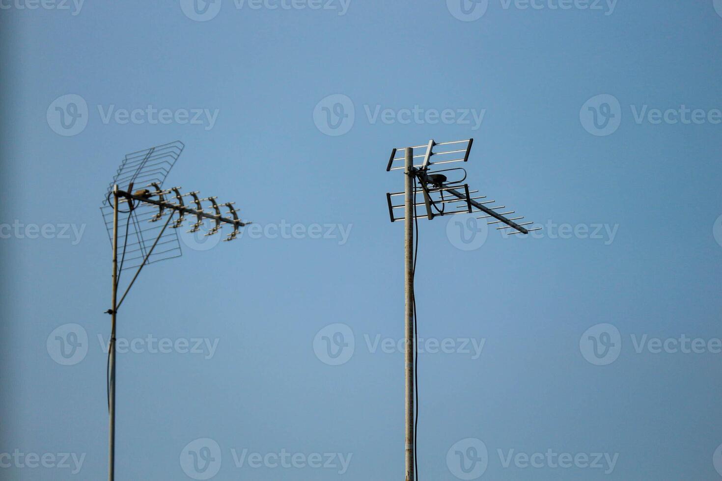 Television antennas that are mounted on the roof of the house photo