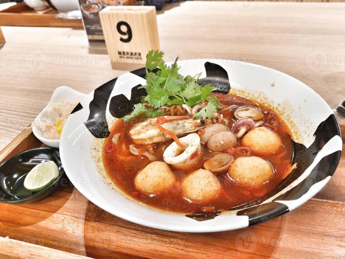 One of the signature ramen from a ramen specialist restaurant. Seafood Tom Yum Ramen. photo