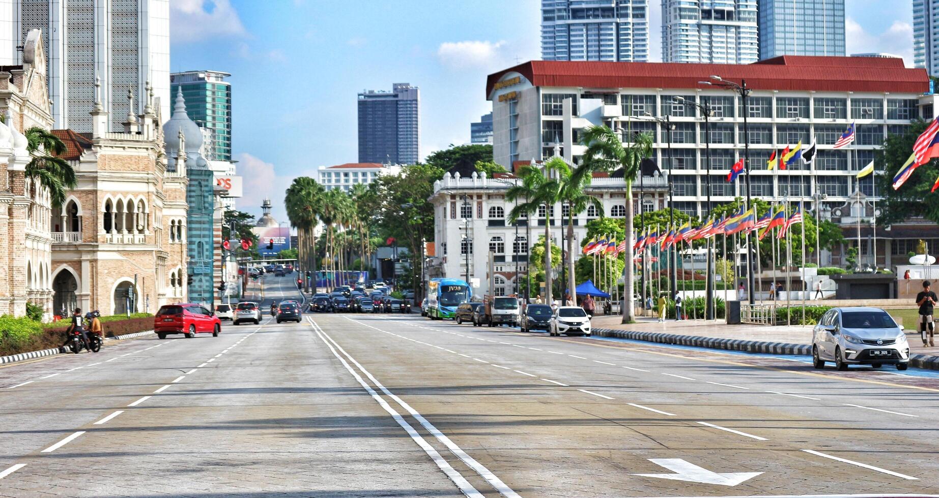 Kuala Lumpur, Malaysia on May 21, 2023. Several cars stop at a red light near the Dataran Merdeka square and Sultan Abdul Samad Building. photo