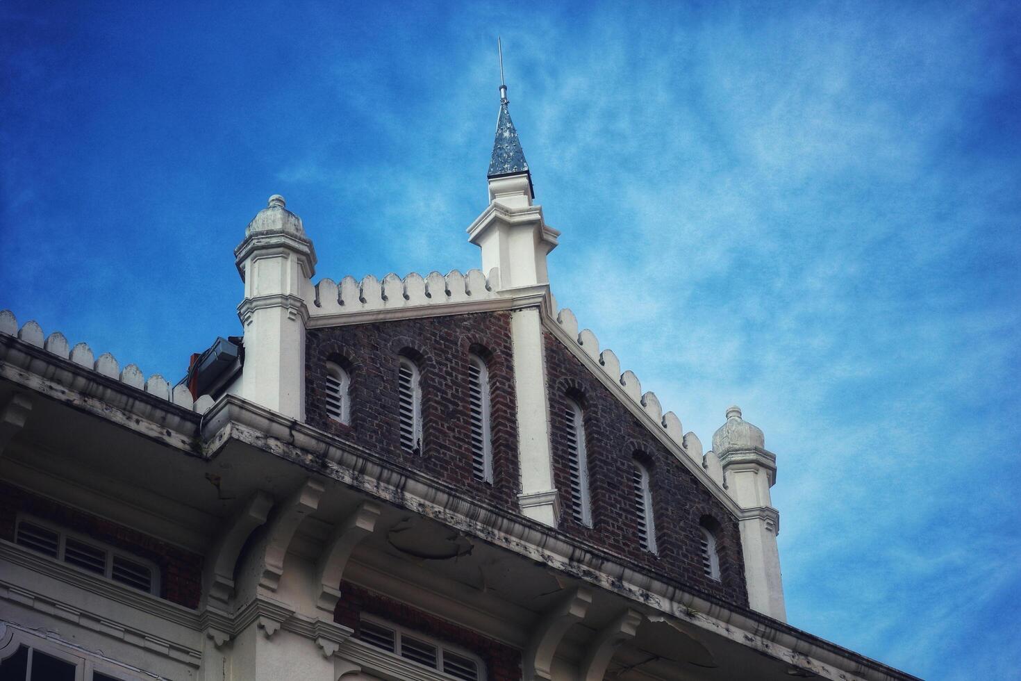 Kuala Lumpur, Malaysia on May 21, 2023. The top of the building and roof of the former chartered bank building, photo