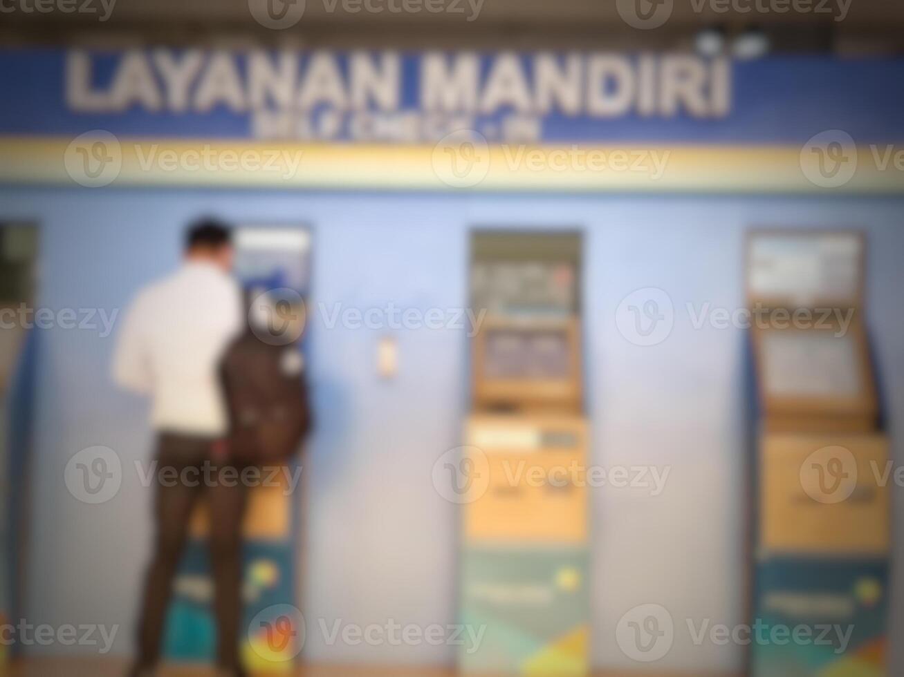 Jakarta, Indonesia on July 7 2022. Defocused photo or blurred photo of an airplane passenger who is self-checking in at the machine available at Halim Perdanakusuma Airport.