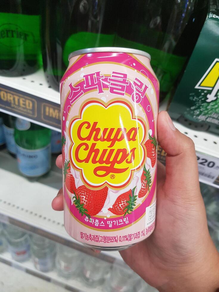 Bangkok, Thailand on July 22, 2023. A hand is holding a can of Chupa Chups Sparkling Strawberry Drink. photo