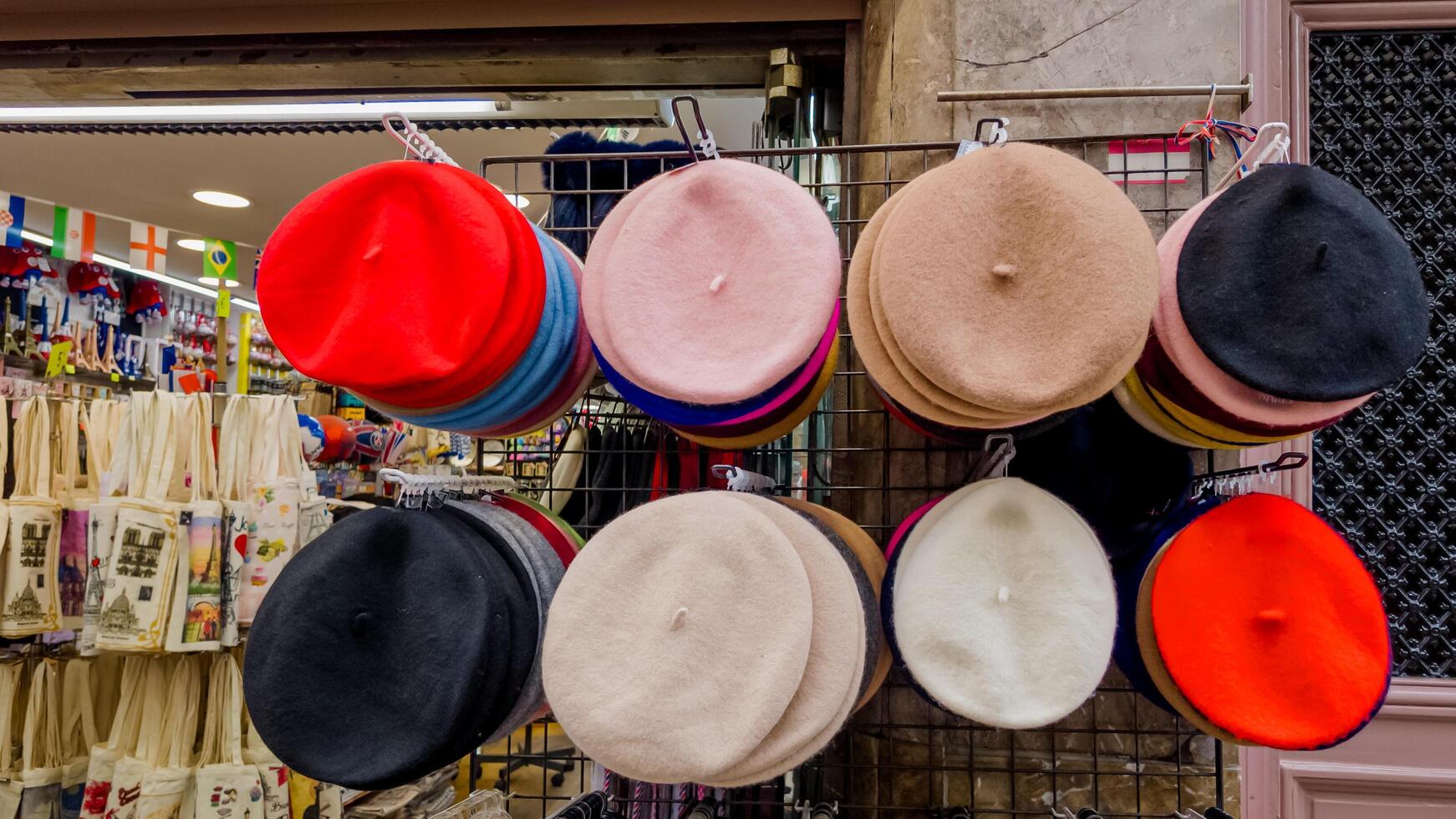 Assorted colorful berets on display in a retail store, representing French fashion and culture, ideal for tourism and fashion concepts photo