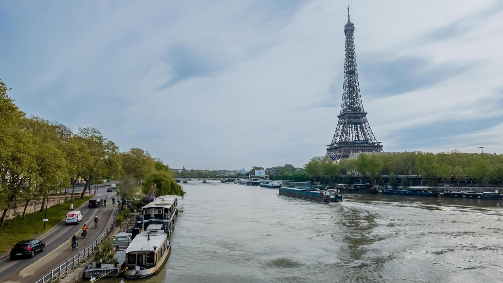 Serene spring day in Paris with the iconic Eiffel Tower overlooking the Seine River, shot in Paris, France, on April 14th, 2024, ideal for travel and tourism themes photo