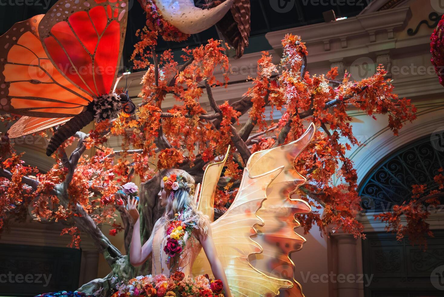 Whimsical fairy figure with golden wings in enchanted indoor display, Las Vegas. photo