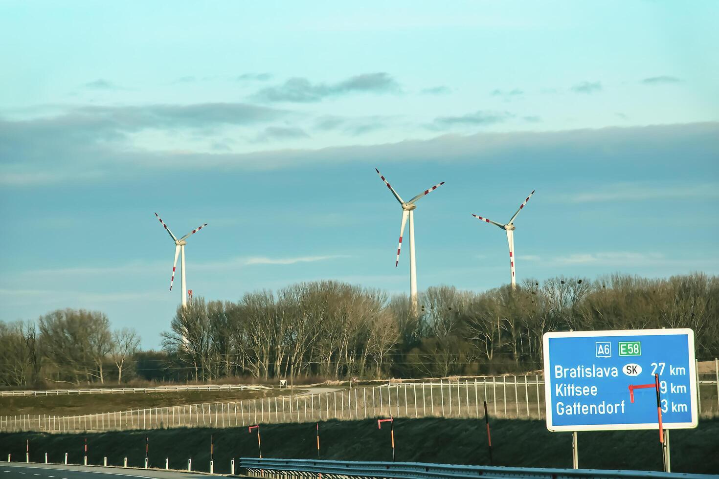 Austria, road to Vienna from Bratislava - 01.14.2024 Wind farm park next to a road in Austria in sunny weather photo